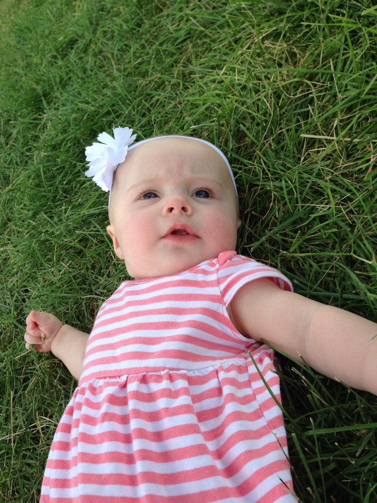 Noelle playing in (and trying to eat) the grass.